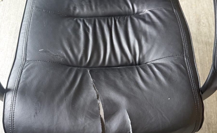 Damaged vinyl chair photographed for repair assessment